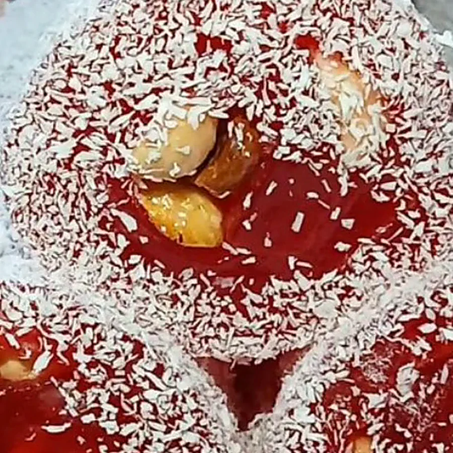 Close-up of a nut roll coated in coconut